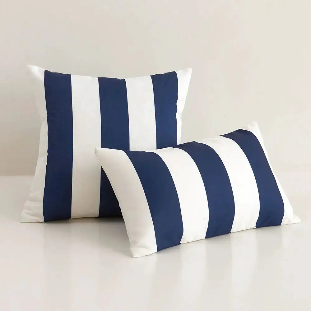 Outdoor pillow covers: two navy and white striped, waterproof covers for couch.
