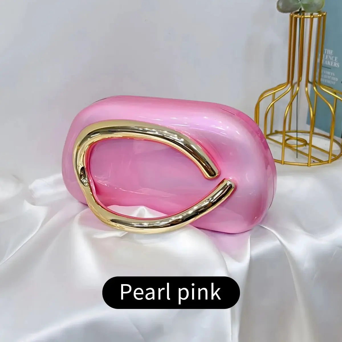 Acrylic box crossbody bag in pearl pink with a gold curved handle by Simples Market