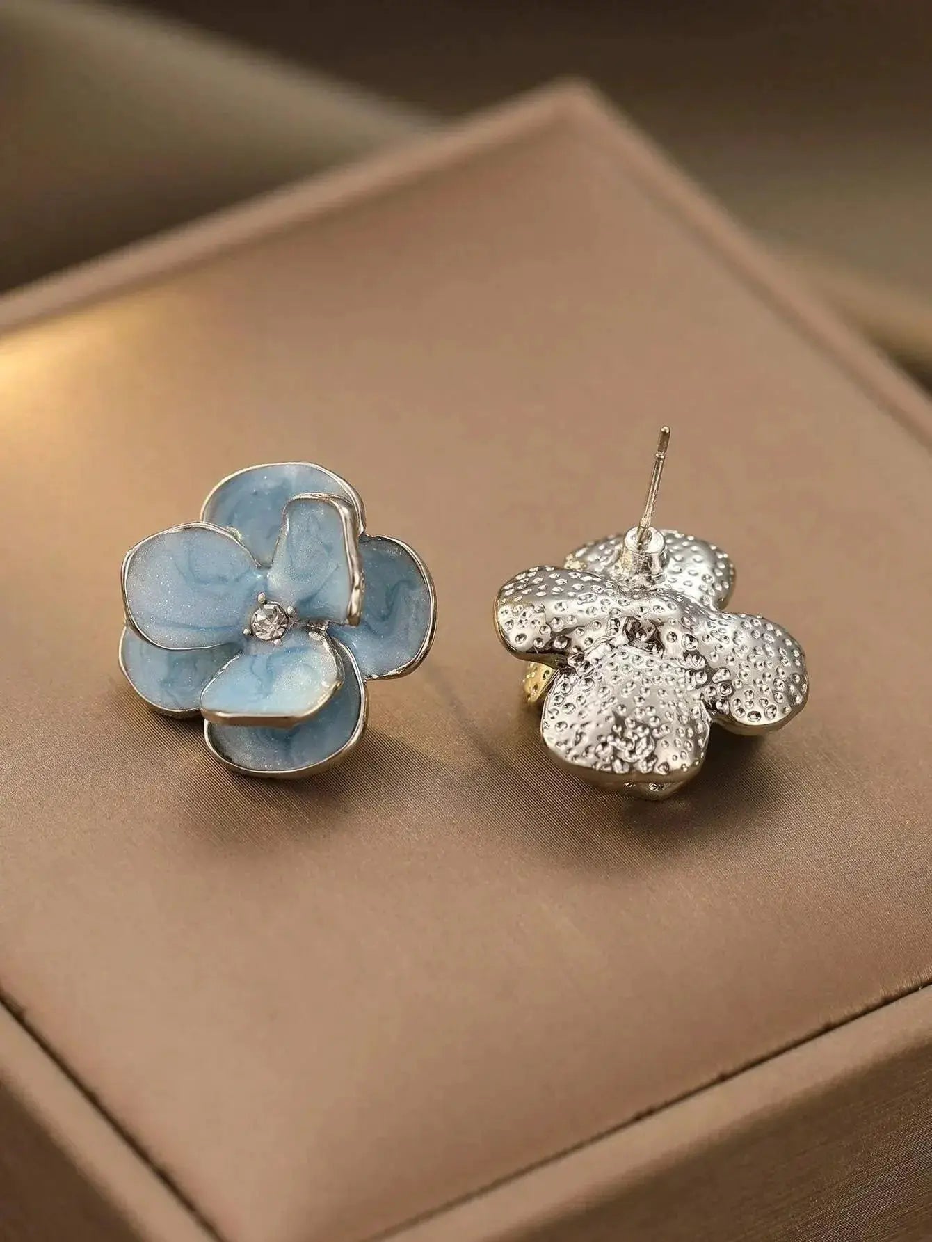 Floral earrings set: blue enamel flower earrings with silver trim and crystal center, plus textured silver flower studs