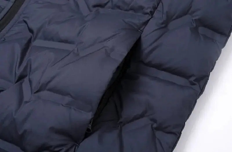 Men's navy blue down puffer jacket with quilted panels and zippered pocket
