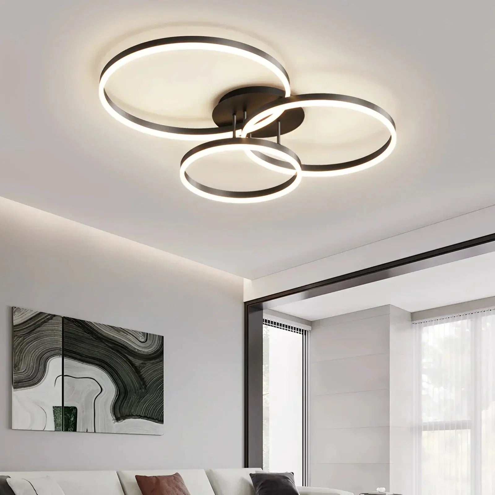 Smart ceiling chandelier by Simples Market with three interconnected circular LED rings in black metal, remote-controlled