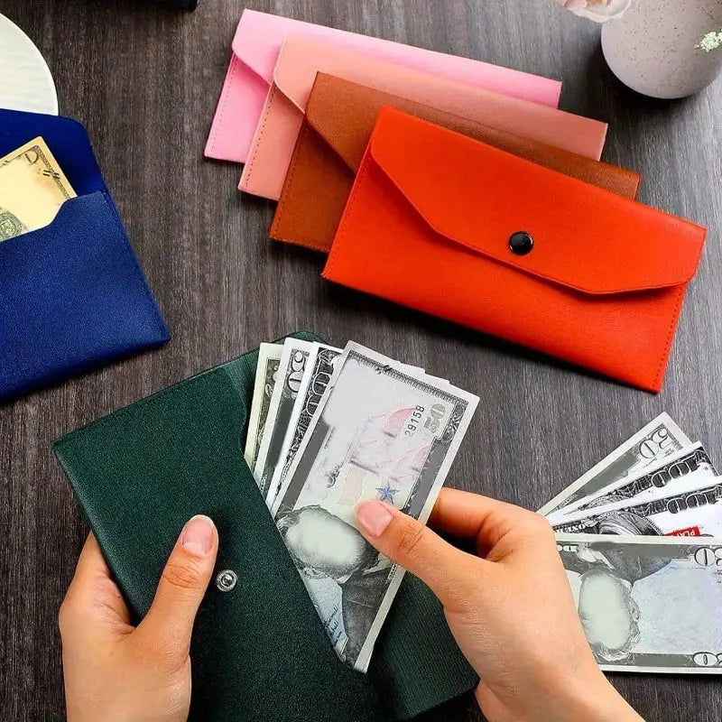 Green leather women's wallet with snap closure and card slots; cash visible, with blue, pink, brown and red wallets in the background.