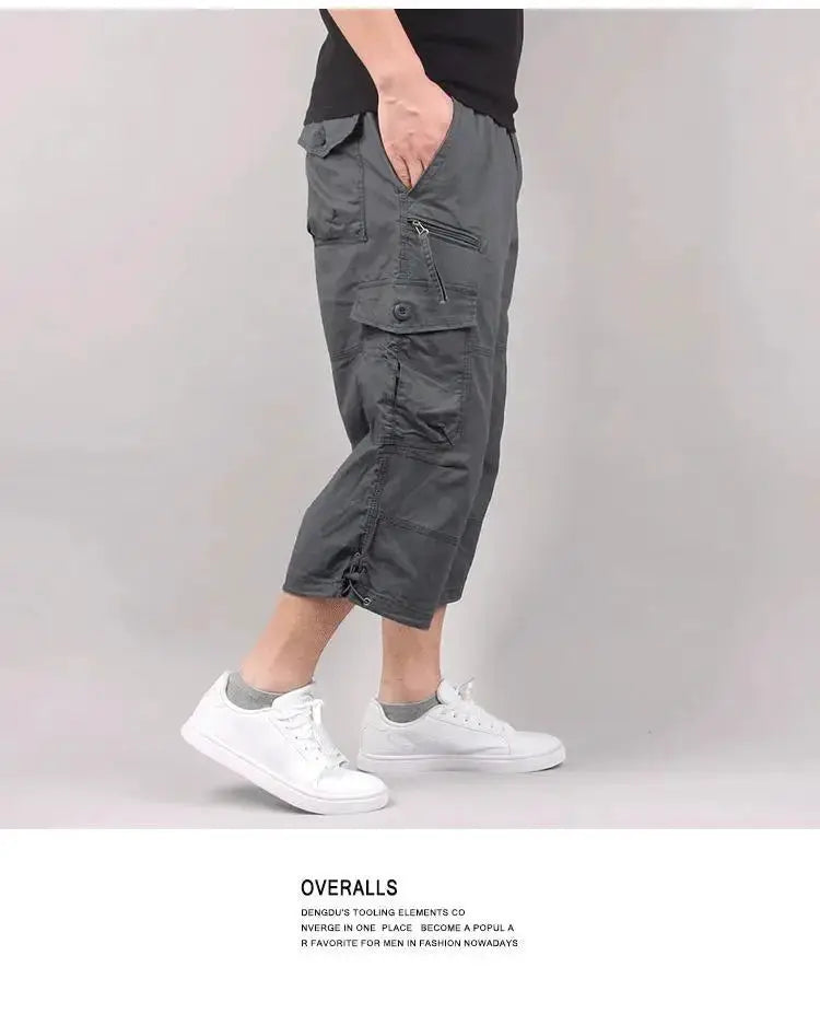 Men's gray cargo shorts with multiple pockets, zippered side pocket, knee-length, elastic waist.