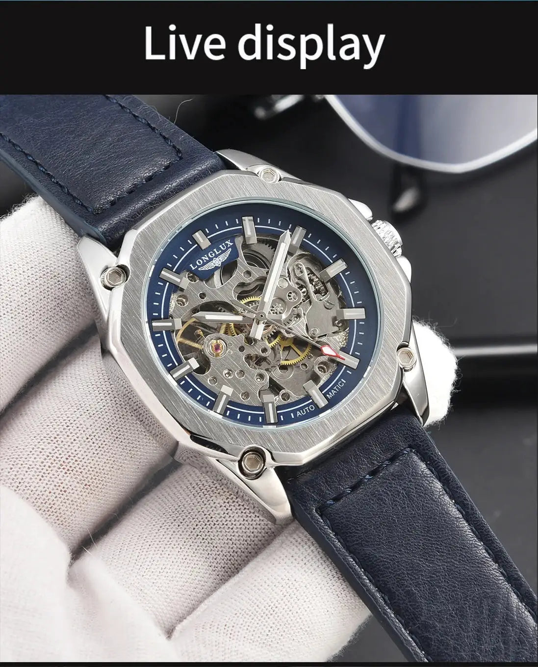 Men's skeleton automatic watch with blue dial, blue leather strap, and stainless steel case.
