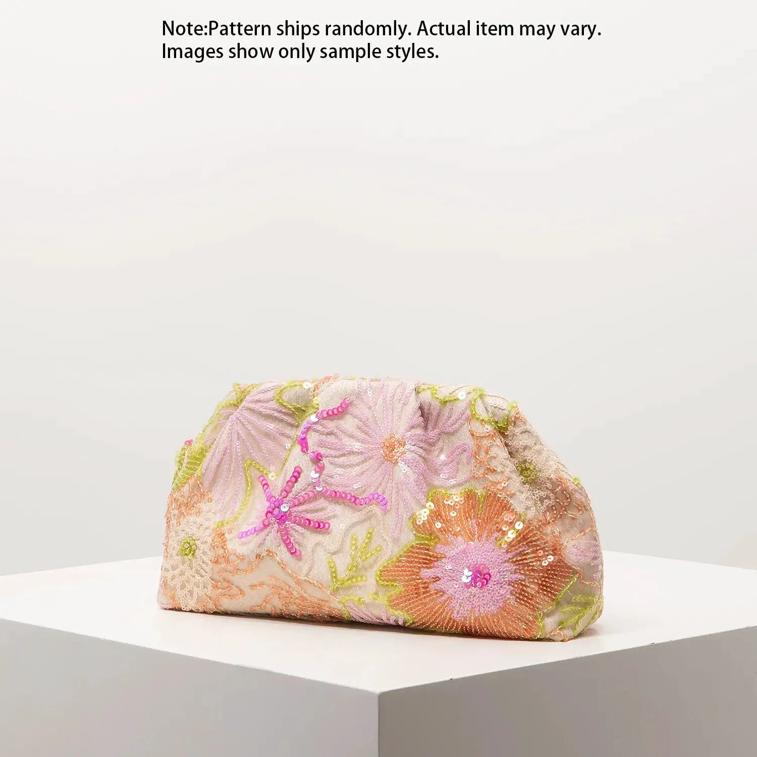 Clutch bag by Simples Market with colorful sequin floral embroidery in pink, peach, lime.