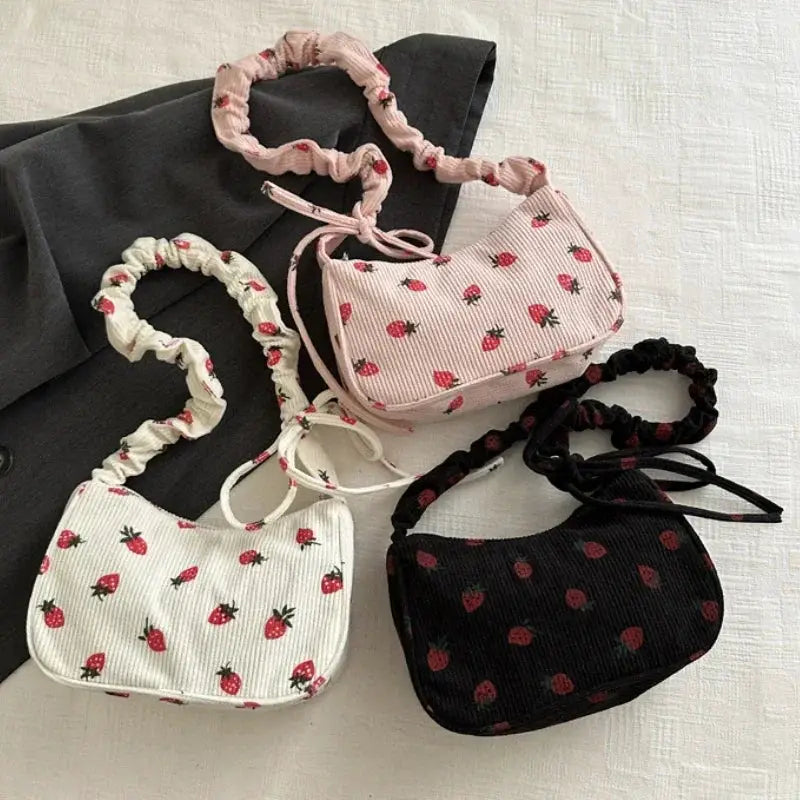 Set of 4 corduroy strawberry-print mini shoulder bags with scrunchie straps in white, pink, light pink and black
