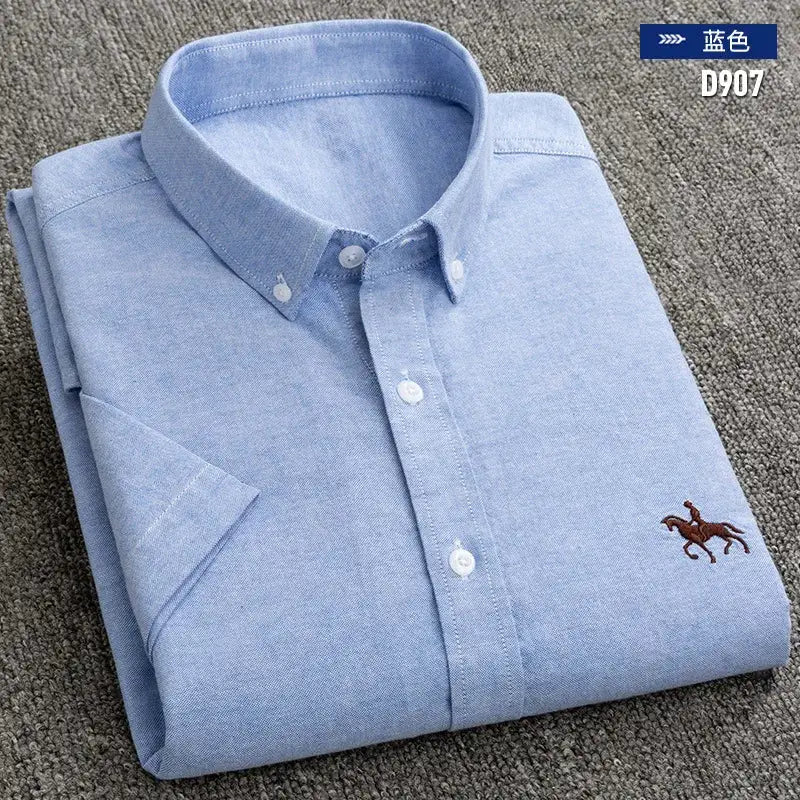 Men's light blue oxford shirt folded with button-front placket and small embroidered horse logo.