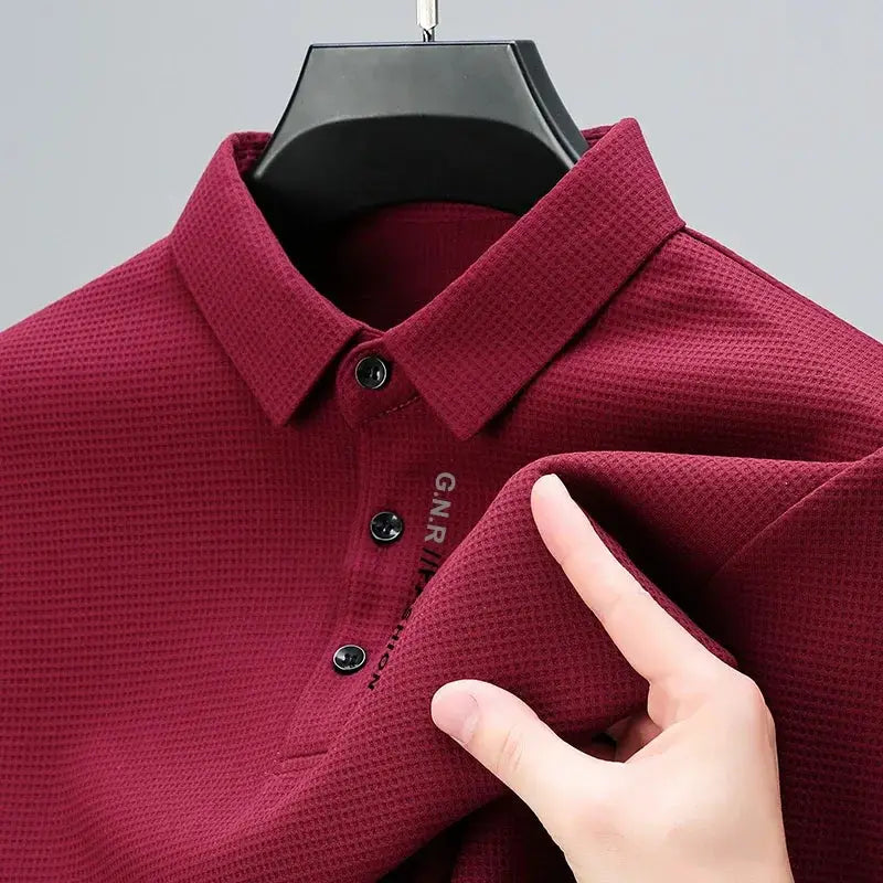Men's burgundy waffle-knit polo shirt with long sleeves and button placket
