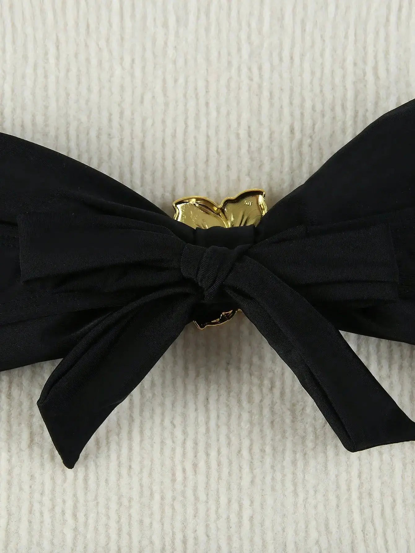 Simples Market black bandeau bikini top with gold bow centerpiece and knot detail.