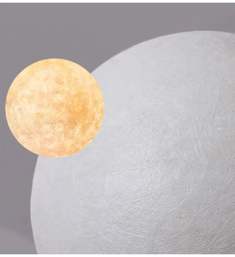 Nordic Moon LED pendant light with white textured globe and warm amber glow