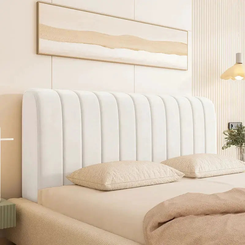 Bed headboard cover by Simples Market in white velvet with padded vertical tufting.