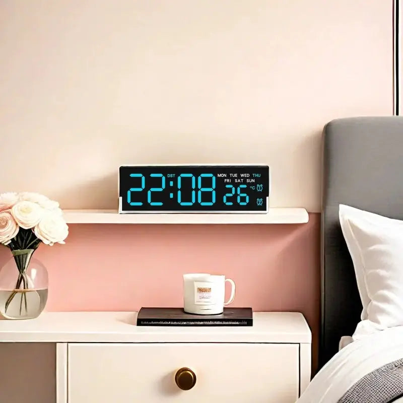 USB powered digital alarm clock with blue LED display on a bedside shelf