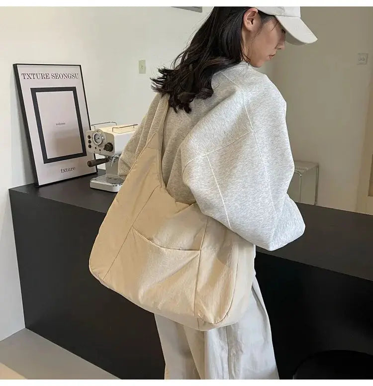 Trendy women's soft beige shoulder bag with front pocket