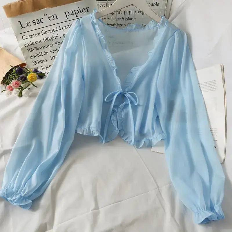 Long-sleeve light-blue sheer blouse with front bow tie and ruffle trim