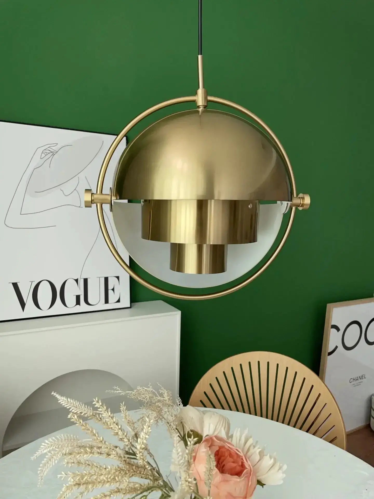 Pendant lamp in gold brass with circular ring frame and dome shade over a kitchen island