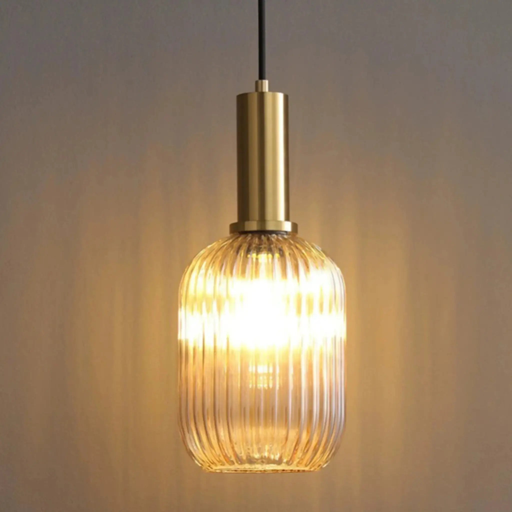 Nordic glass pendant light by Simples Market; brass top with ribbed amber shade, single hanging lamp