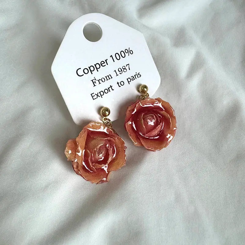 Pair of long pink epoxy rose earrings with real rose petals and gold-tone findings, Simples Market