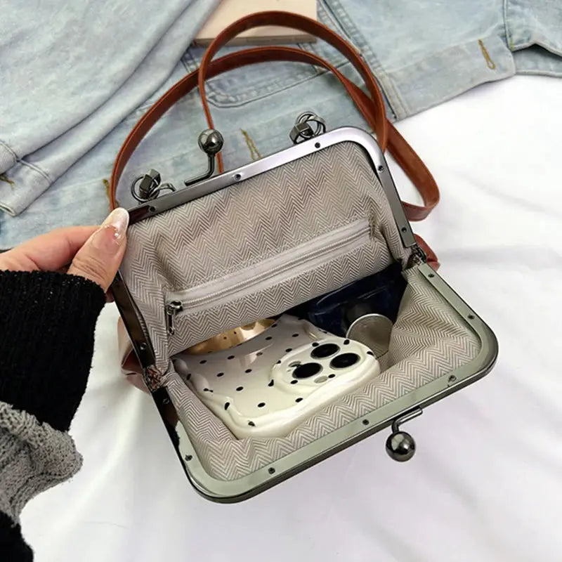 Vintage brown PU leather crossbody handbag with metal frame; chevron lining and a phone inside, Simples Market.
