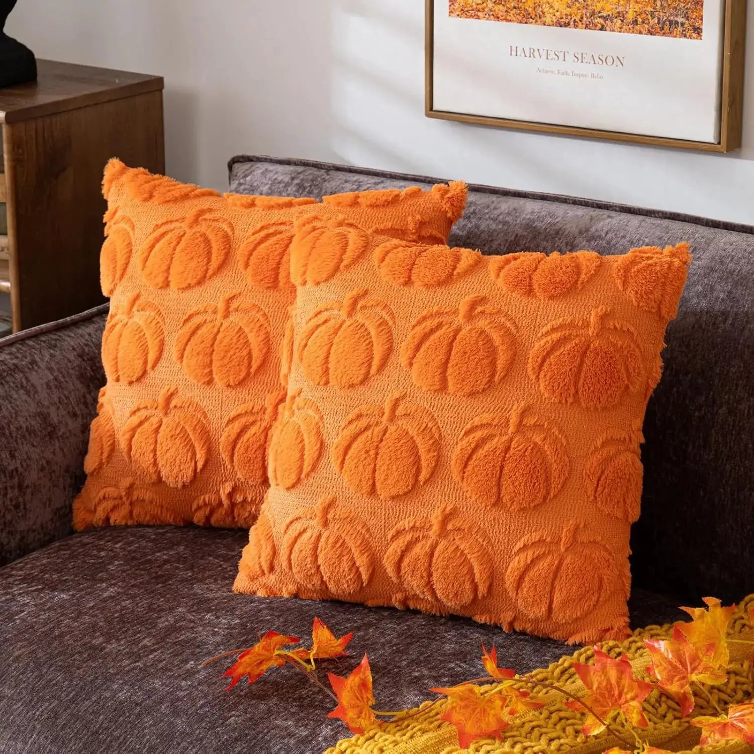 Orange pumpkin-pattern faux-fur throw pillows on a brown sofa
