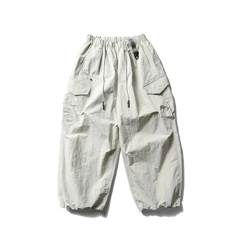 Ultra loose wide-leg outdoor cargo pants in beige with drawstring waist and cargo pockets.