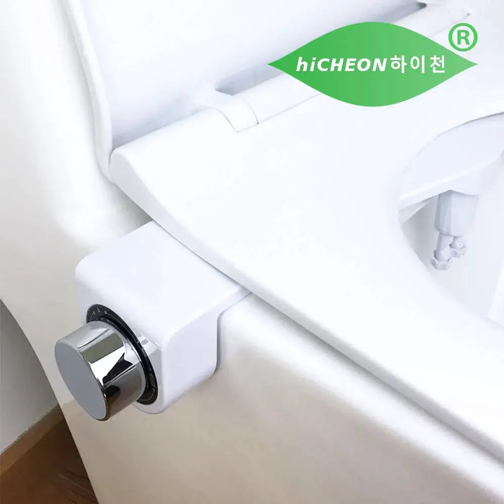 Small bidet toilet seat attachment by hiCHEON with dual nozzles, white plastic and chrome knob