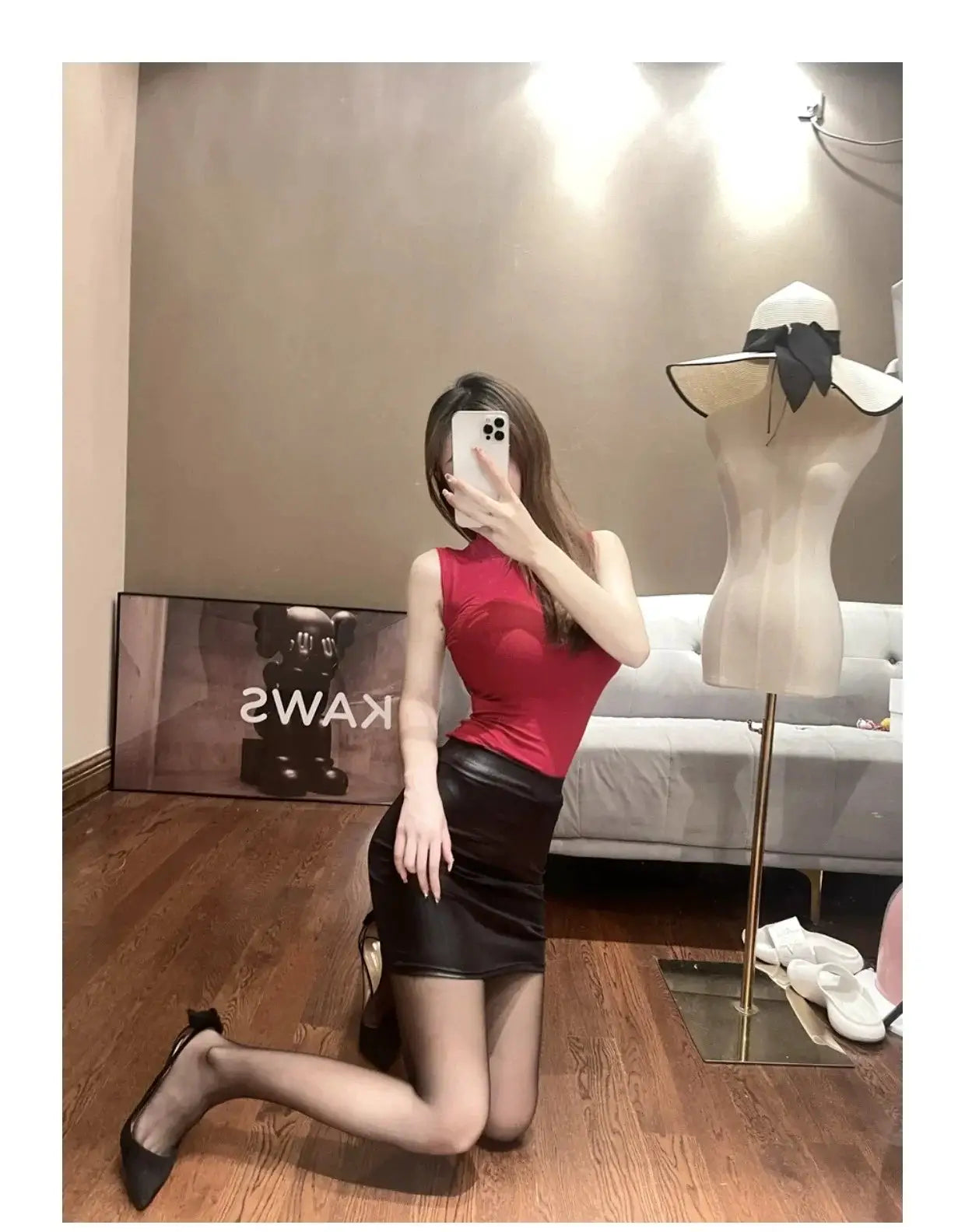 Leather matte slim mini PU skirt, black, high-waisted; worn by a model in a boutique.