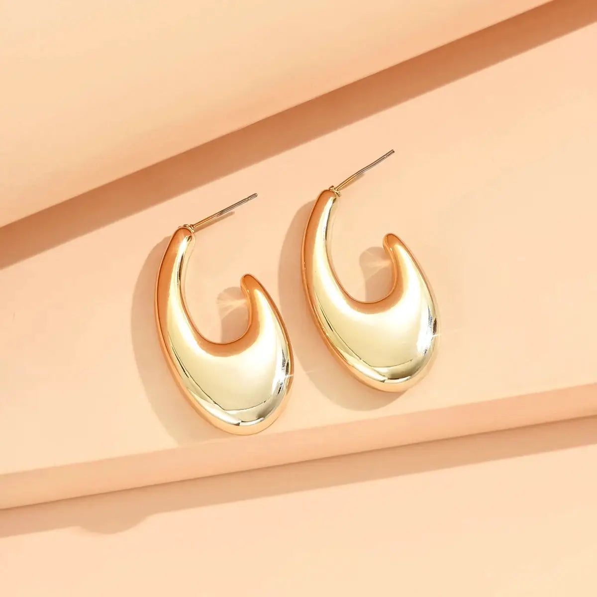 Gold-tone crescent hoop earrings; polished metal finish, set of two for women.