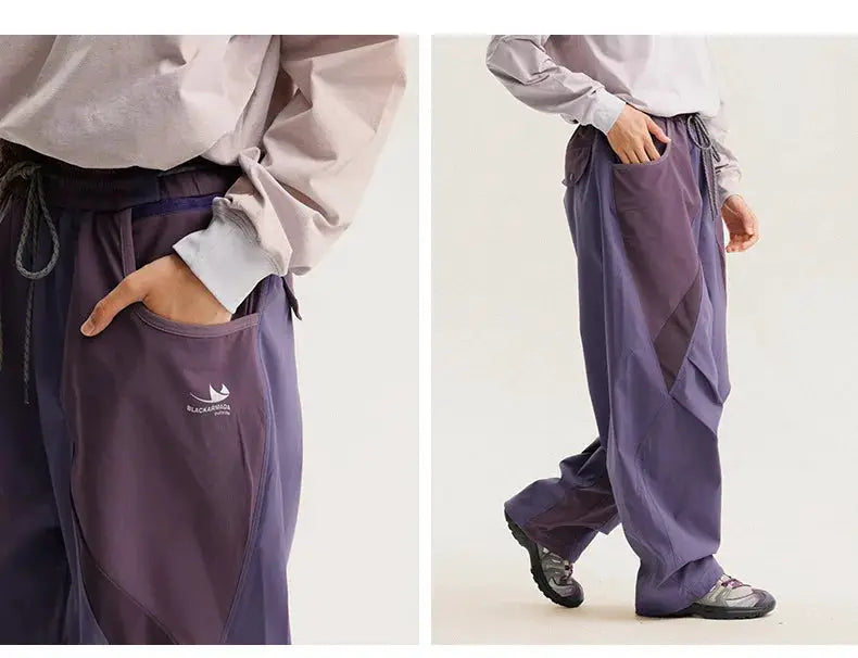 Purple men's cargo track pants with wide legs, drawstring waist, and Black Armada logo on pocket