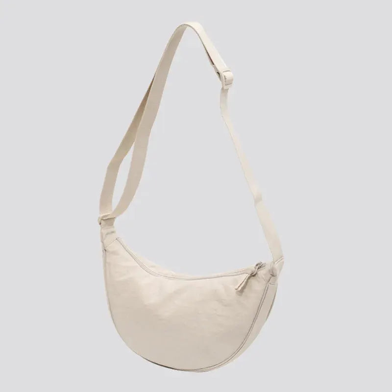 Beige solid-color women's crossbody bag with adjustable strap and zip closure