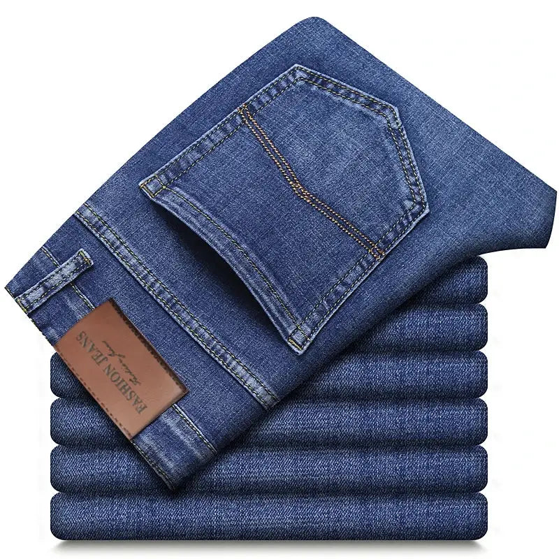 Blue denim jeans folded with back pocket and leather patch label; casual workwear