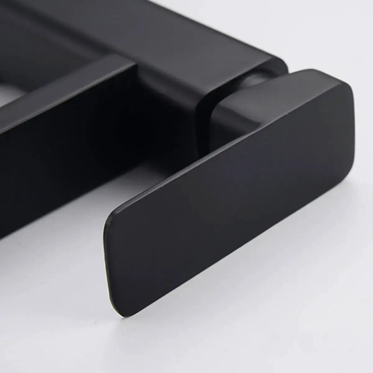 Black matte deck-mounted bathroom faucet lever with modern rectangular design