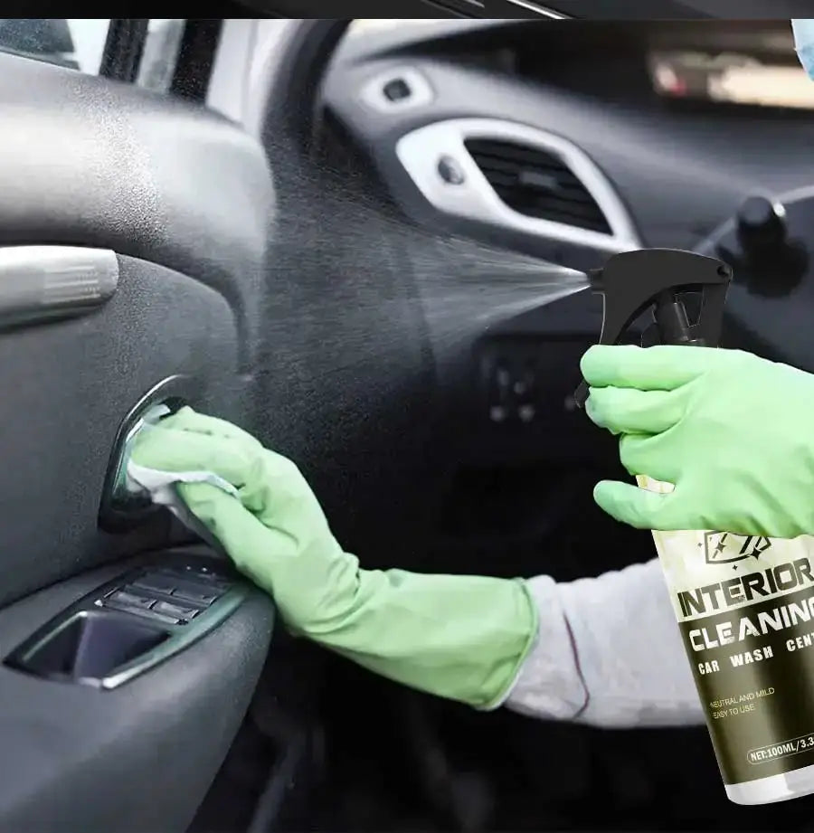 Ryekew Car interior cleaner spray used on a car dashboard by a gloved hand wearing green gloves