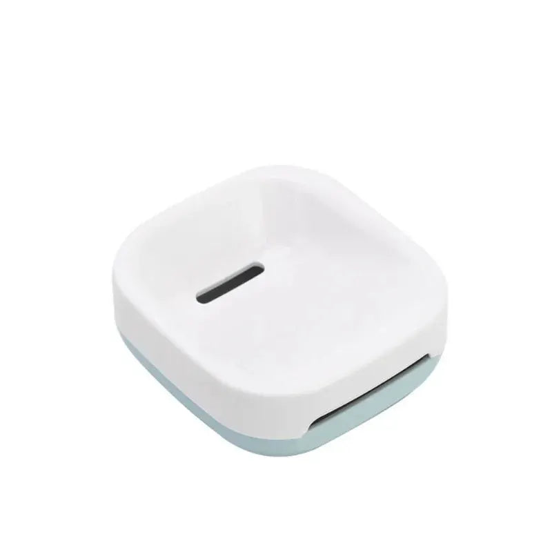 Electric toothbrush holder; white plastic countertop organizer with light blue base
