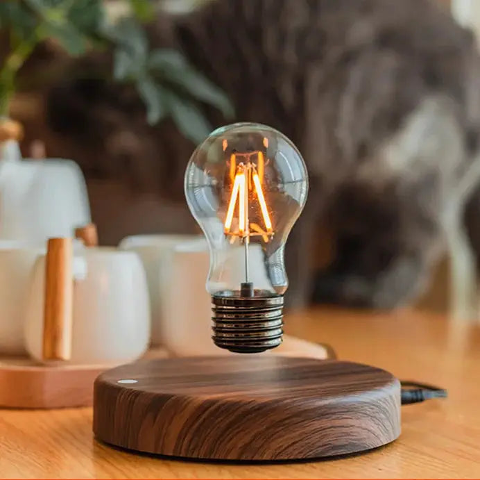 Magnetic levitation lamp with floating glass LED bulb above a wooden base for home office decor