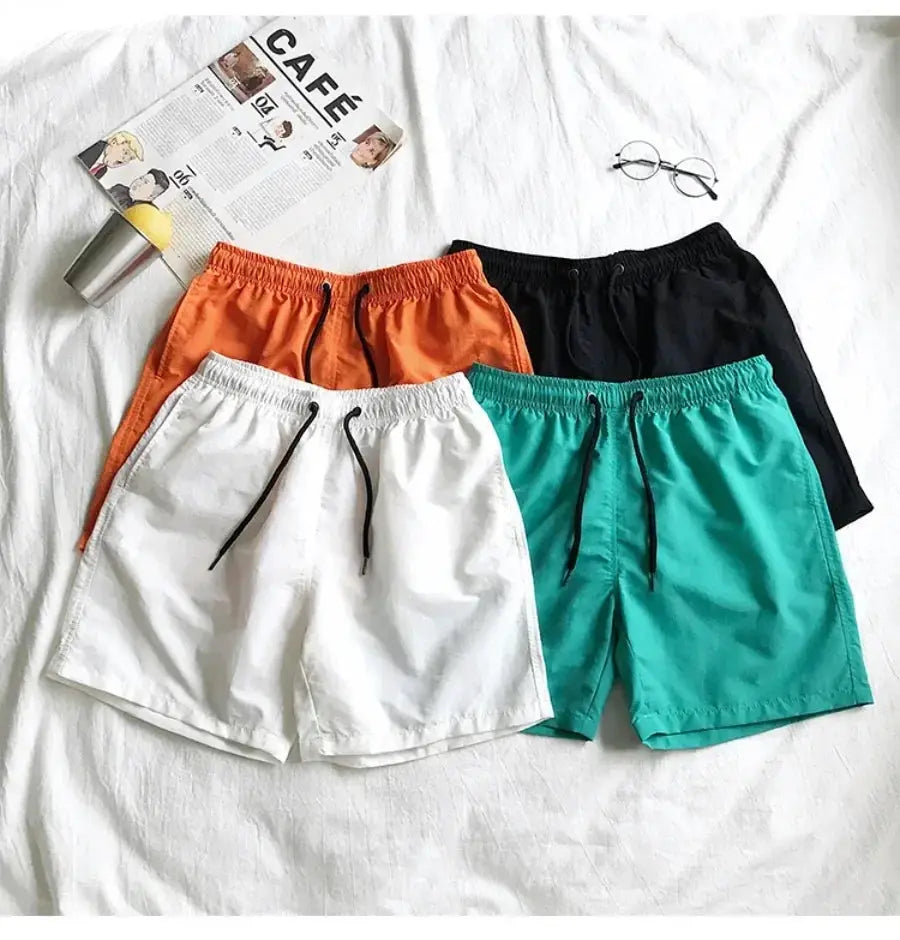 Men's swim shorts set by Simples Market, four colorways (orange, white, teal, black) with drawstring waist.