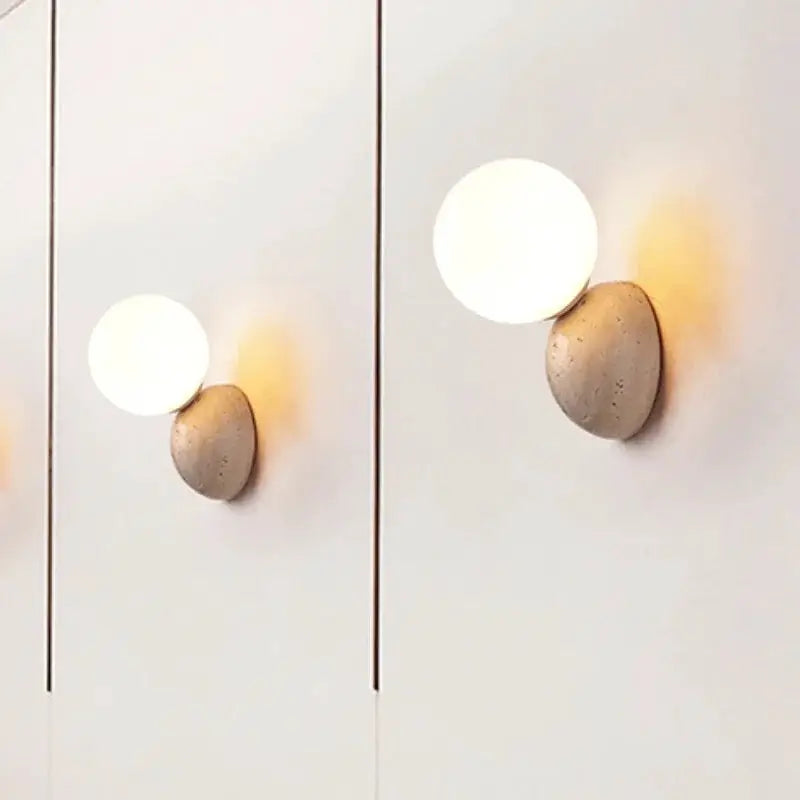 Cream-style LED wall lamp with round white glass globe on a stone base, two-pack for bedroom or living room