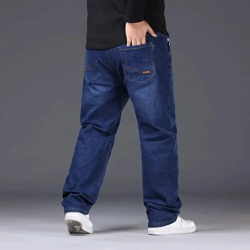 Men's blue denim jeans, oversized loose fit with high waist, back view.