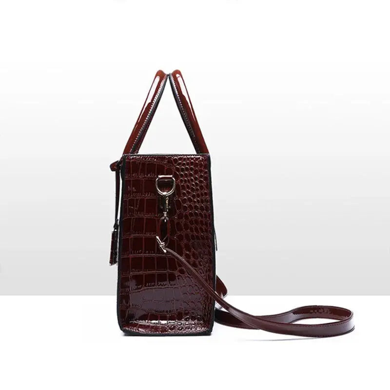 Crocodile-pattern PU leather handbag with burgundy finish, top handles, and detachable crossbody strap.