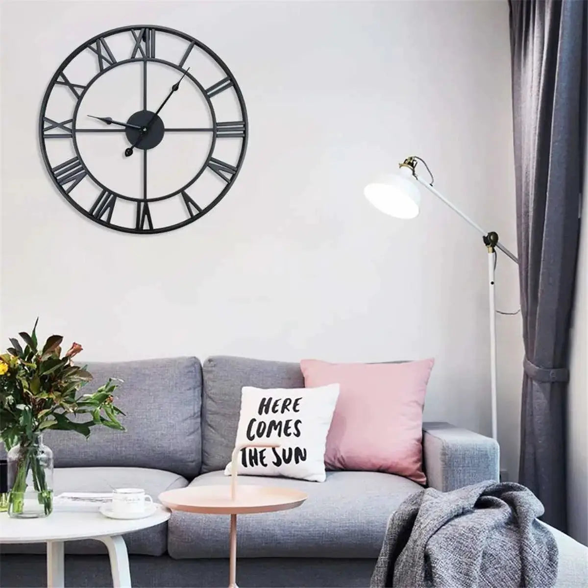 Modern 3D large wall clock with Roman numerals, round black metal wall decor in living room.