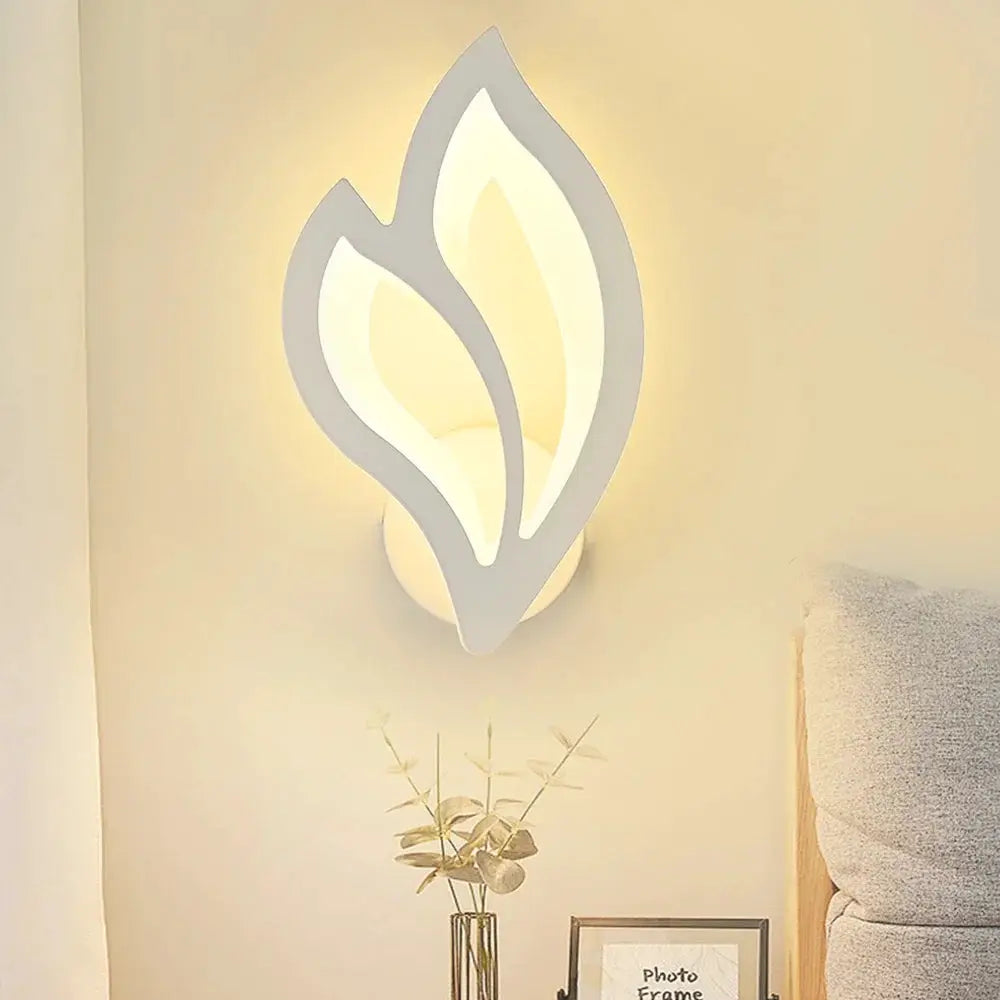 Modern LED leaf-shaped wall lamp with white frame and warm glow for living room decor