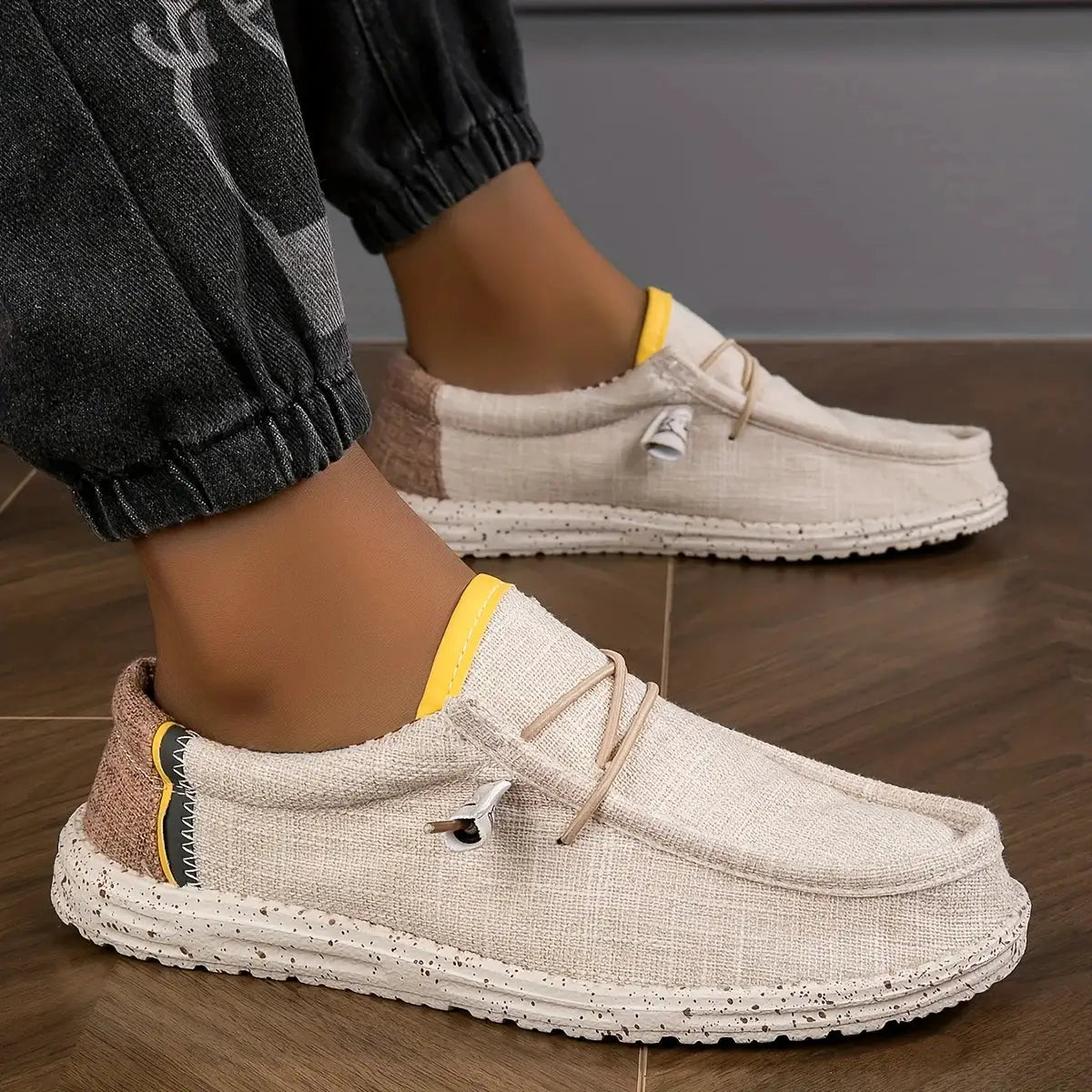 Pair of men's canvas loafers in beige with yellow trim, breathable casual driving shoes with speckled sole
