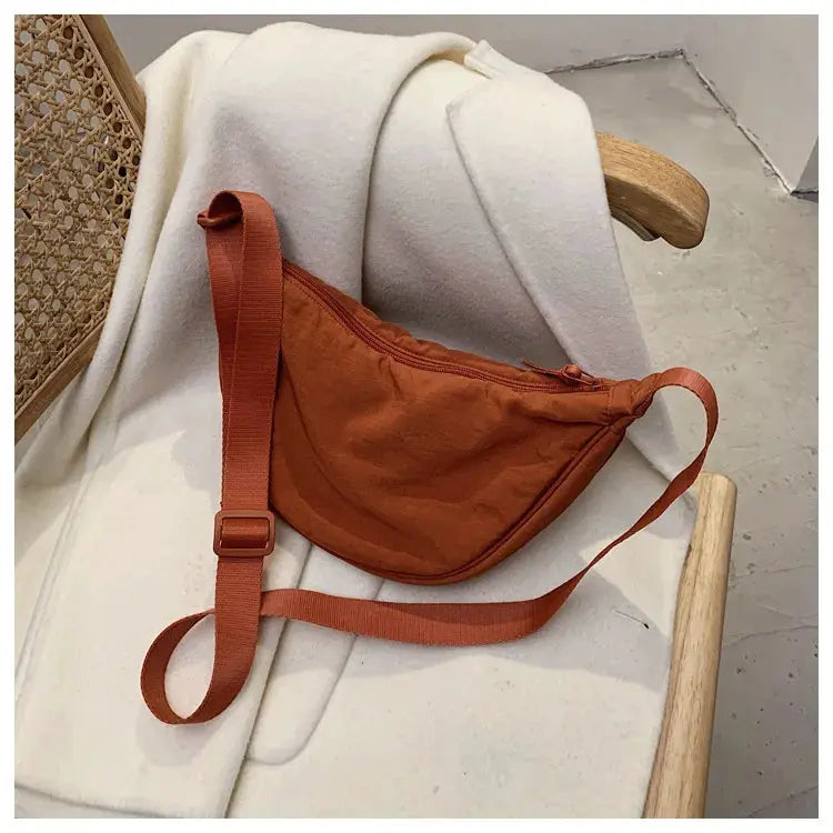 Casual nylon hobo crossbody bag in burnt orange with adjustable strap by Simples Market