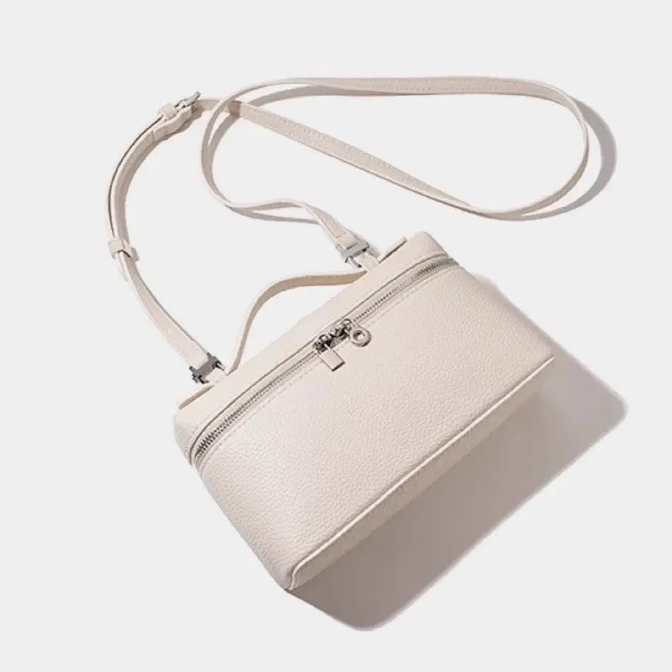Cream lychee-grain mini shoulder bag with adjustable crossbody strap and top zip