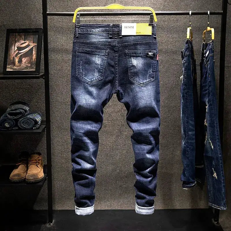 Men's ripped blue-black denim jeans, straight fit with back pockets and rolled cuffs