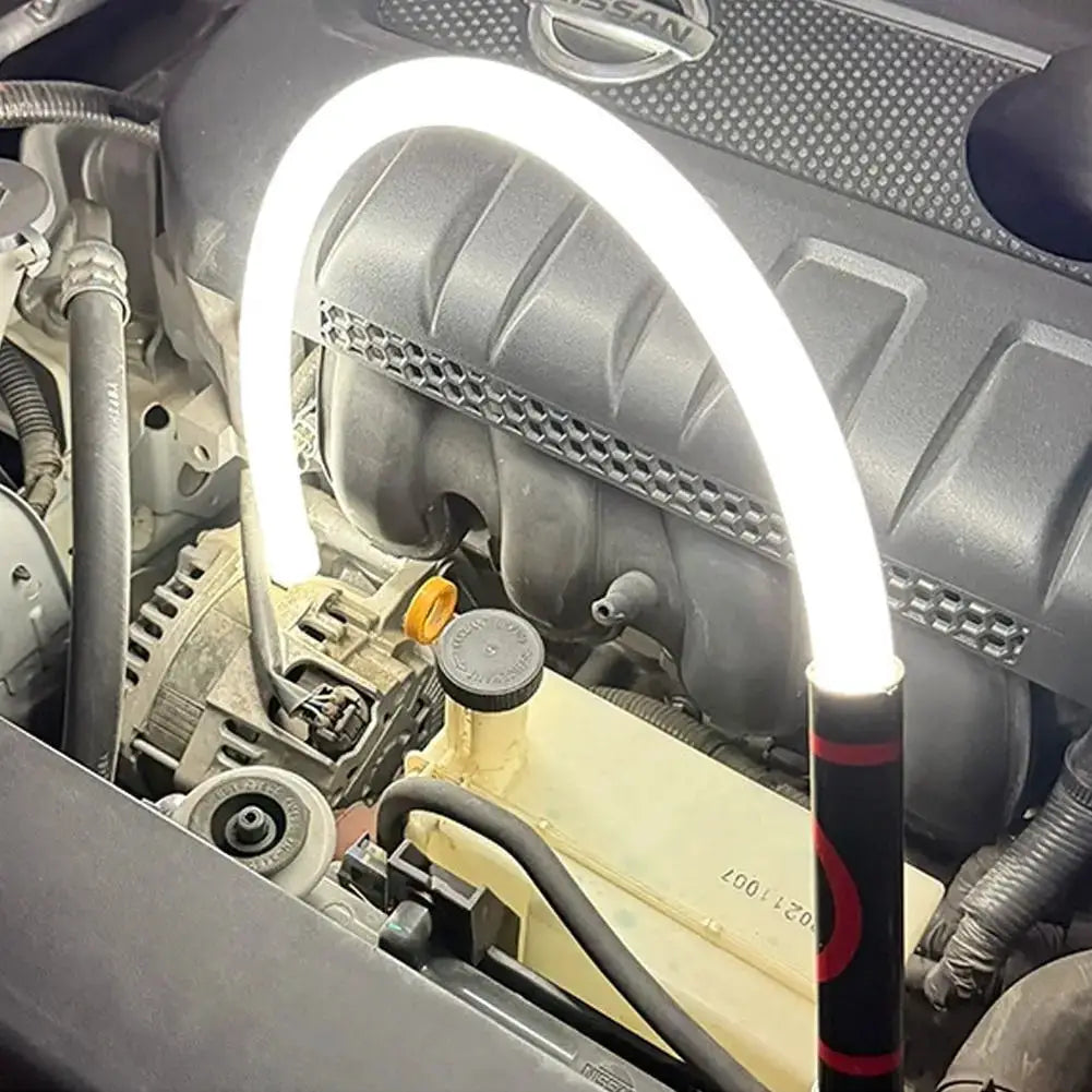 73cm flexible LED flashlight stick, rechargeable work light in Nissan engine bay; white LED ring, black/red handle.