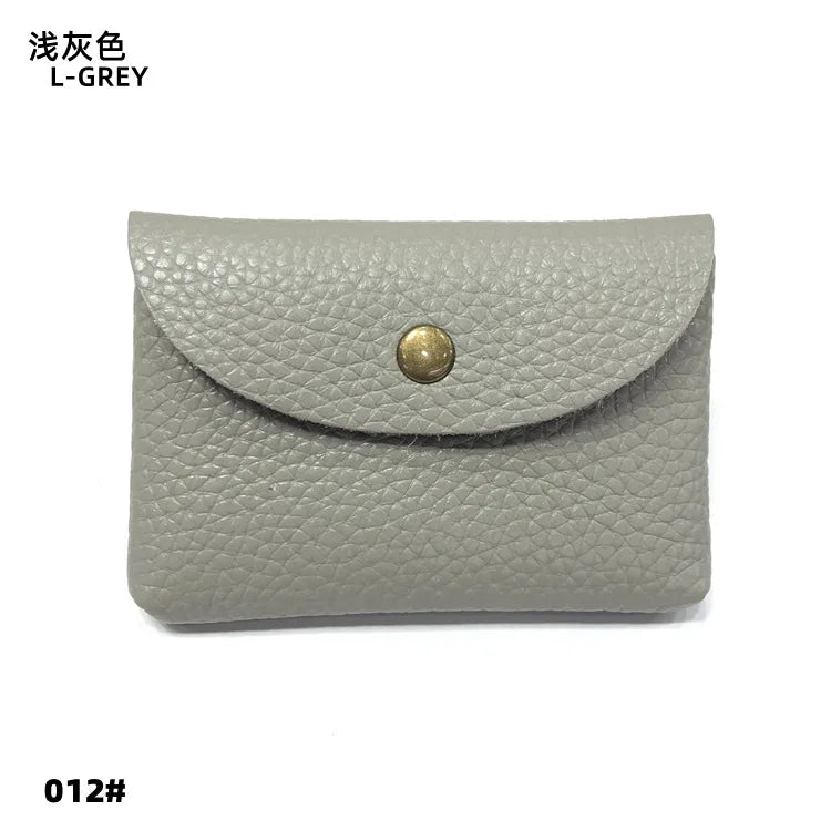 Genuine leather card holder by Simples Market in light gray, envelope-style mini sleeve with brass snap