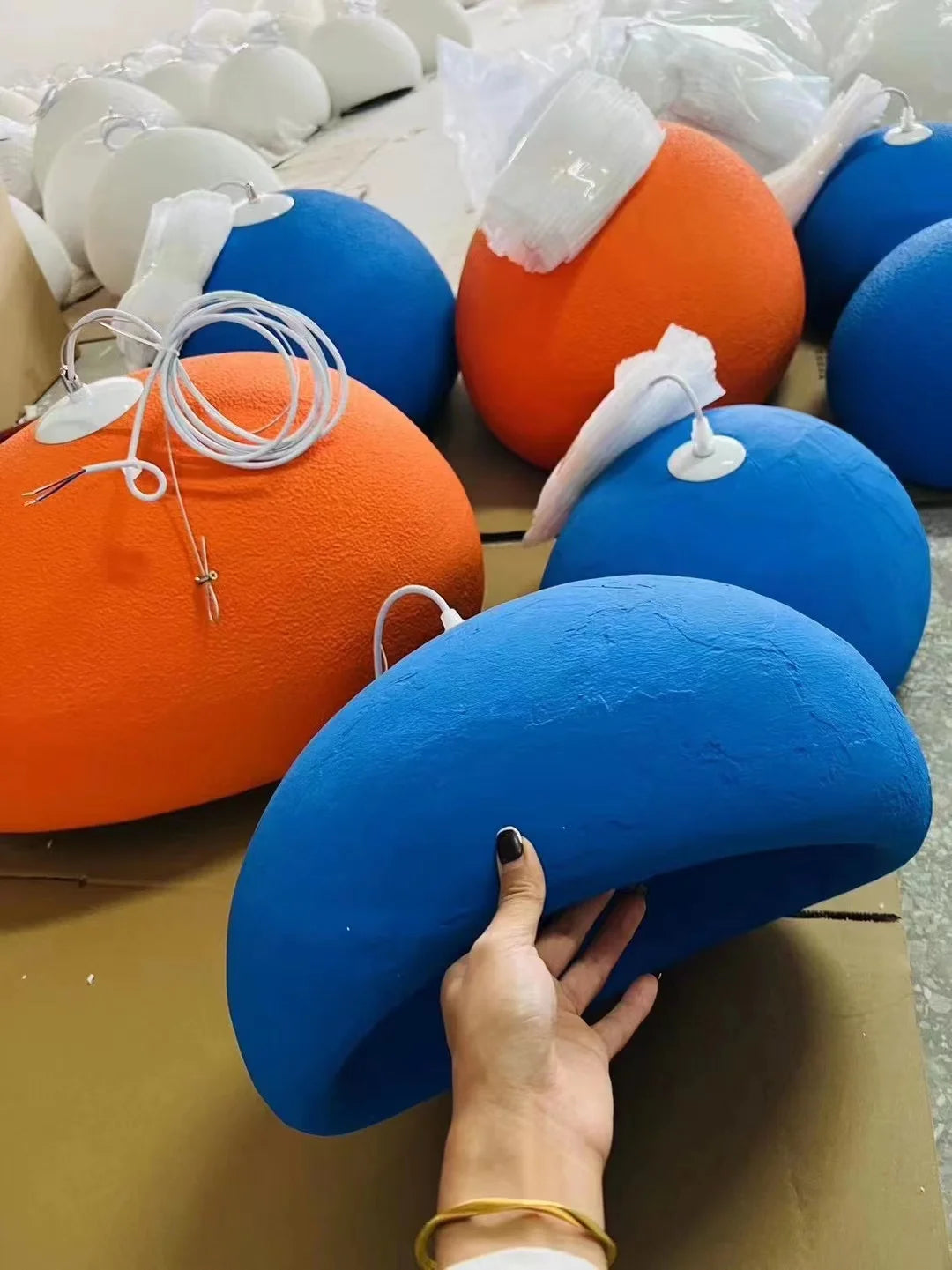 Nordic Wabi Sabi LED pendant lights set in blue and orange hemispheres with white cords