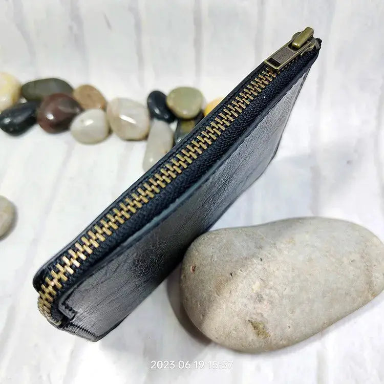 Simples Market mini leather zip waist bag; compact black wallet with gold zipper for cards, ID, passport and phone.