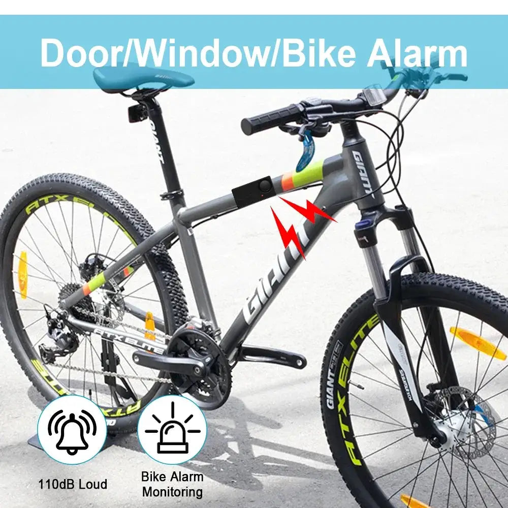 Anchtek 110dB wireless bike alarm with remote mounted on gray mountain bike, black alarm module on top tube