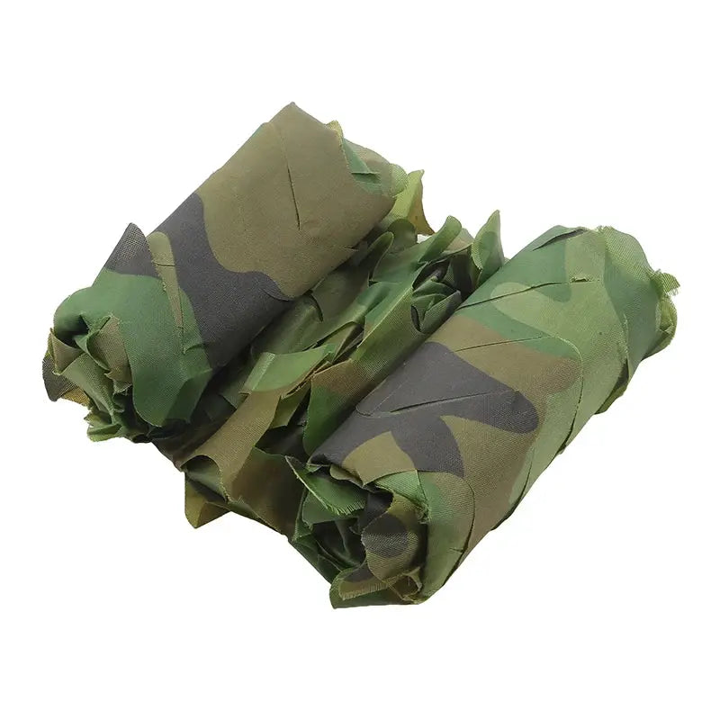 Military camouflage netting in woodland pattern, rolled fabric in green/brown/black for outdoor use